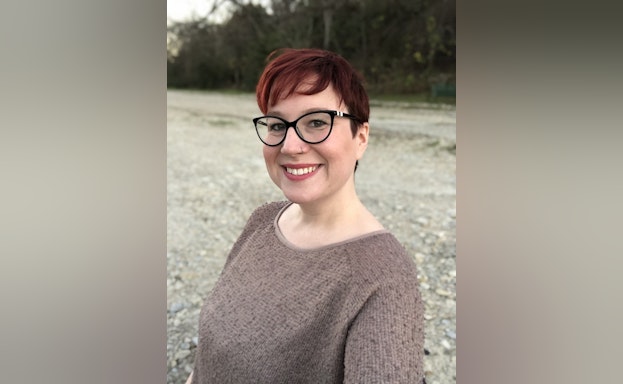 Woman smling in front of field