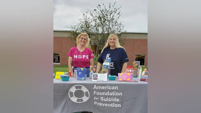 Two women standing at AFSP table