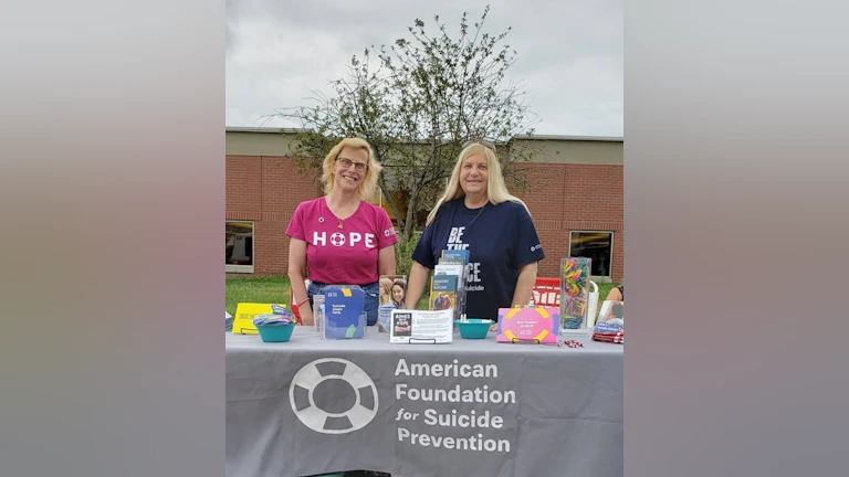 Two women standing at AFSP table
