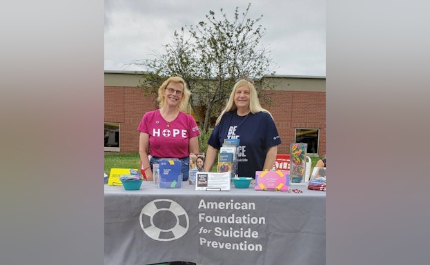Two women standing at AFSP table