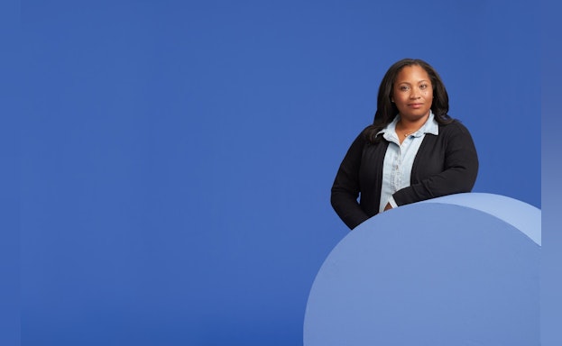 Woman in front of blue background
