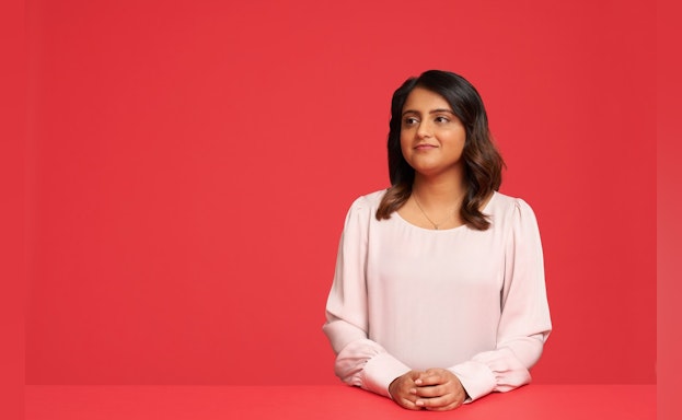 Woman in front of red background