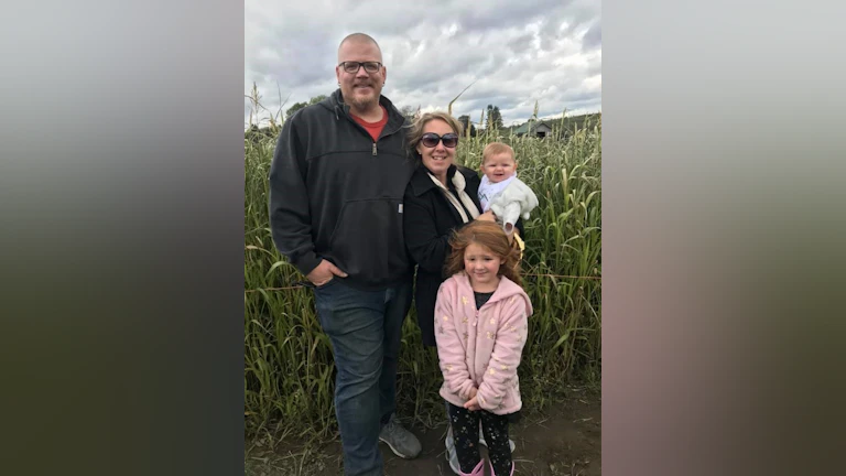 Group standing in corn field