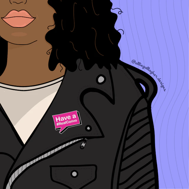 Have a #RealConvo pin on woman's jacket