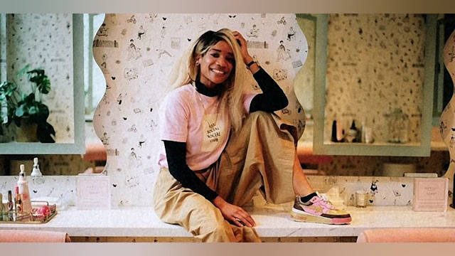 A photo of Elyse Fox sitting on a counter and smiling
