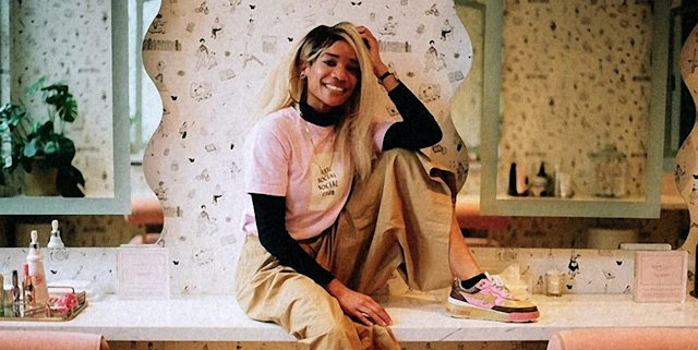 A photo of Elyse Fox sitting on a counter and smiling