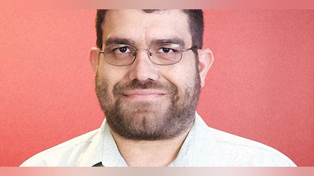 Man in front of red background