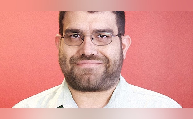 Man in front of red background