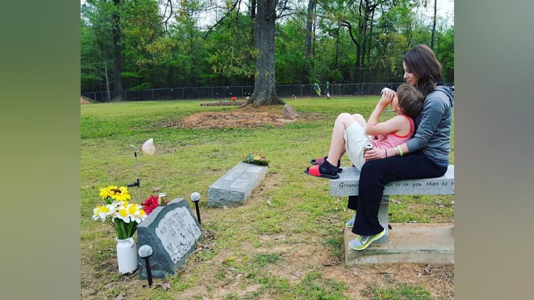 Woman and child at gravesite