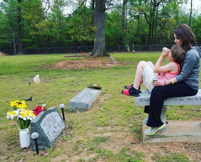Woman and child at gravesite