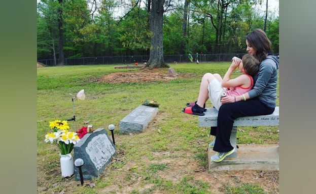 Woman and child at gravesite