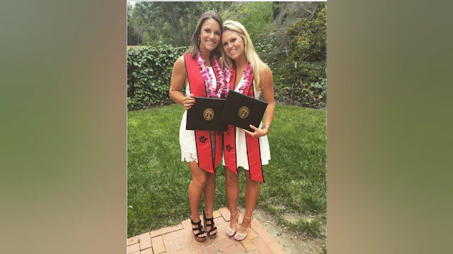 Two women with diplomas
