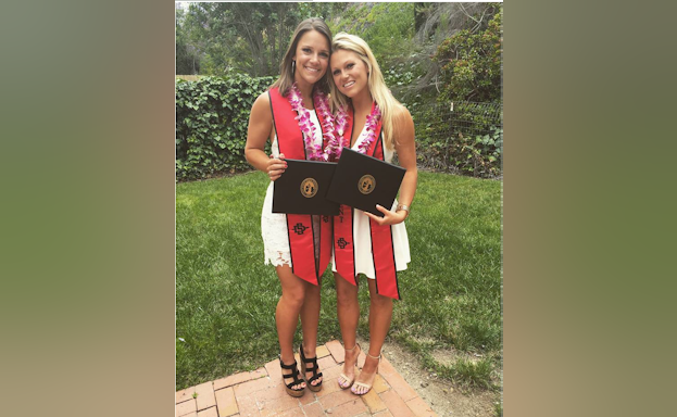 Two women with diplomas