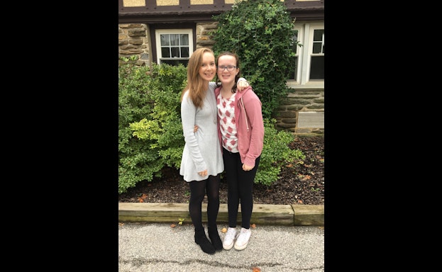 two sisters smiling and embracing