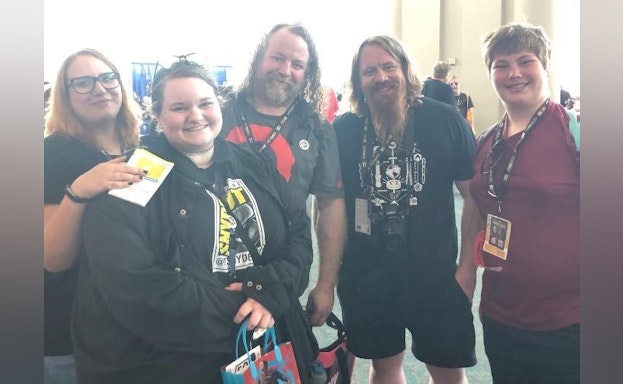 group of men and women smiling