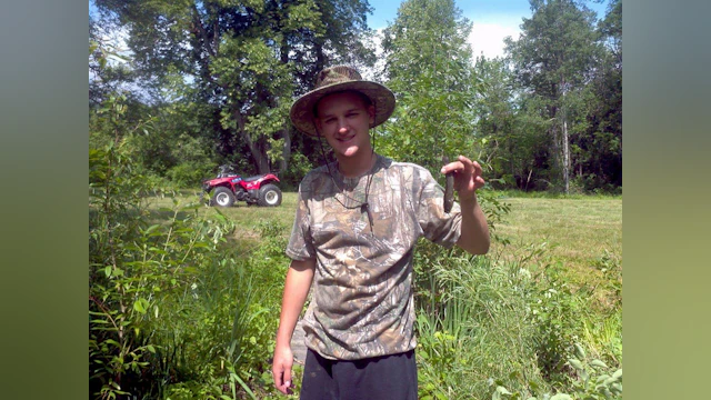 Young man holding fish