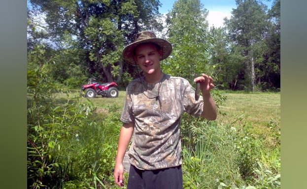 Young man holding fish