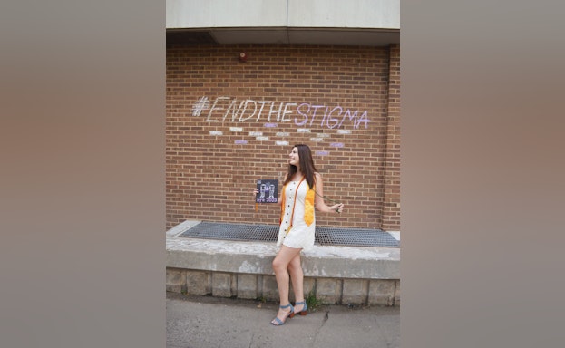 Woman in front of brick wall