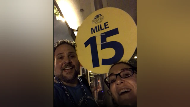 Man and woman in front of mile marker 15
