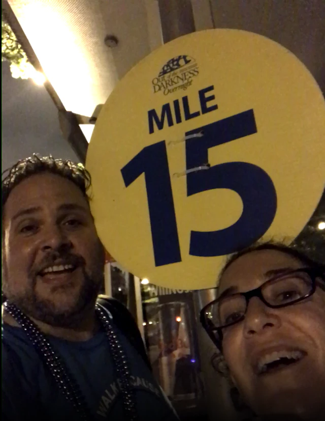 Man and woman in front of mile marker 15