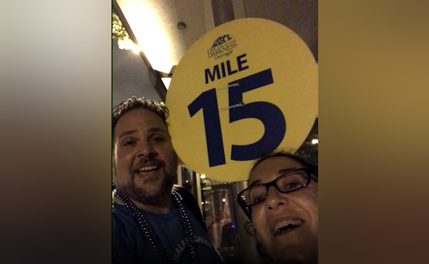 Man and woman in front of mile marker 15
