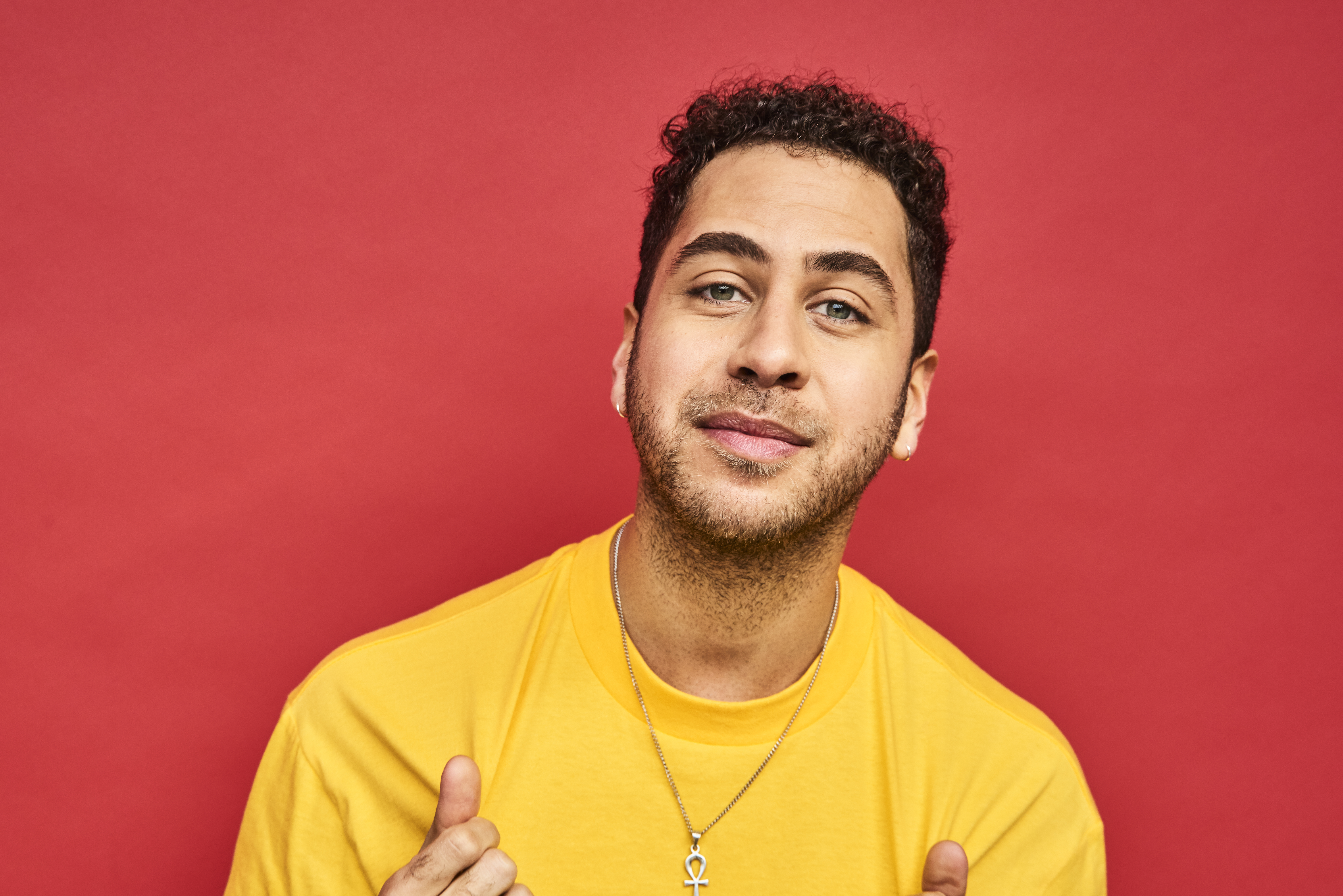 Man in front of red background