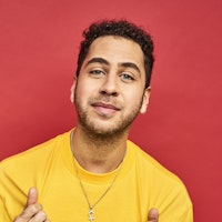 Man in front of red background