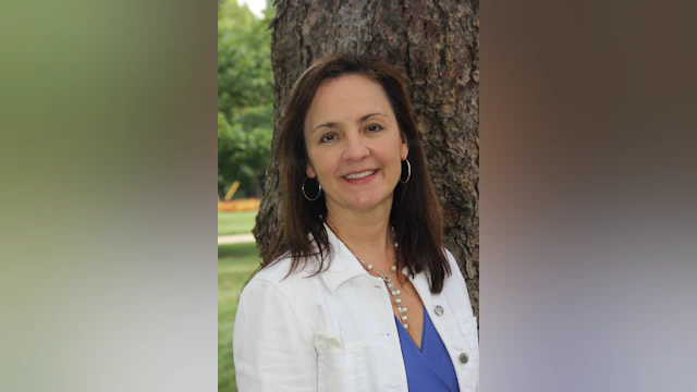Woman in front of tree