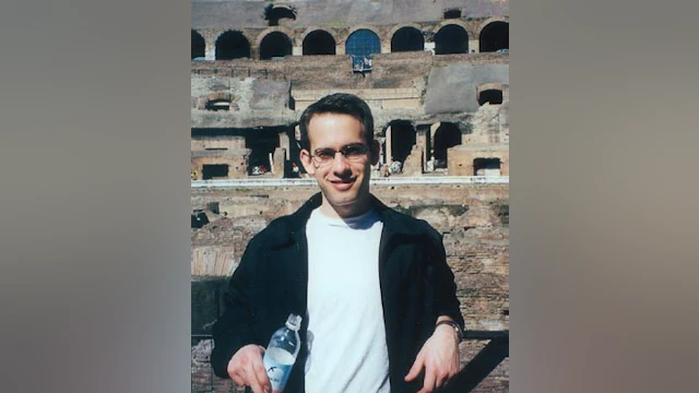 Man standing in front of colosseum