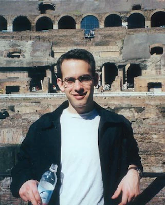 Man standing in front of colosseum