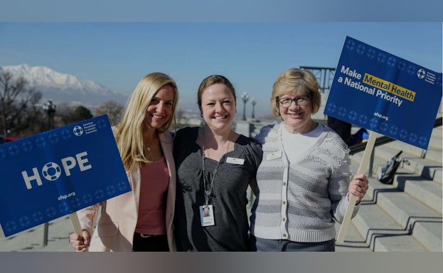 Volunteers holding advocacy signs