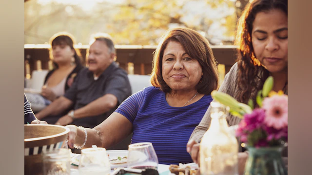 Hispanic family eating outdoors