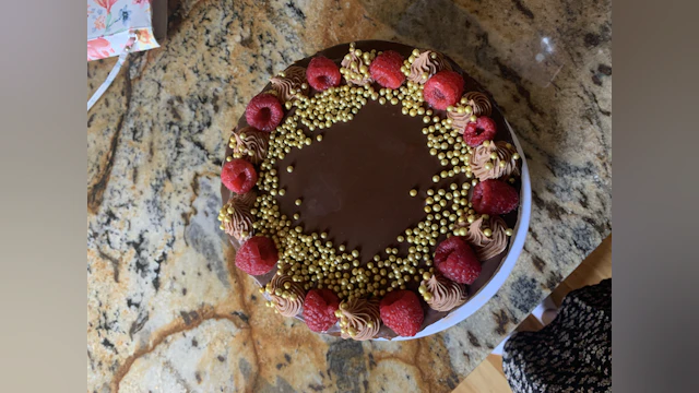 Chocolate cake topped with raspberries
