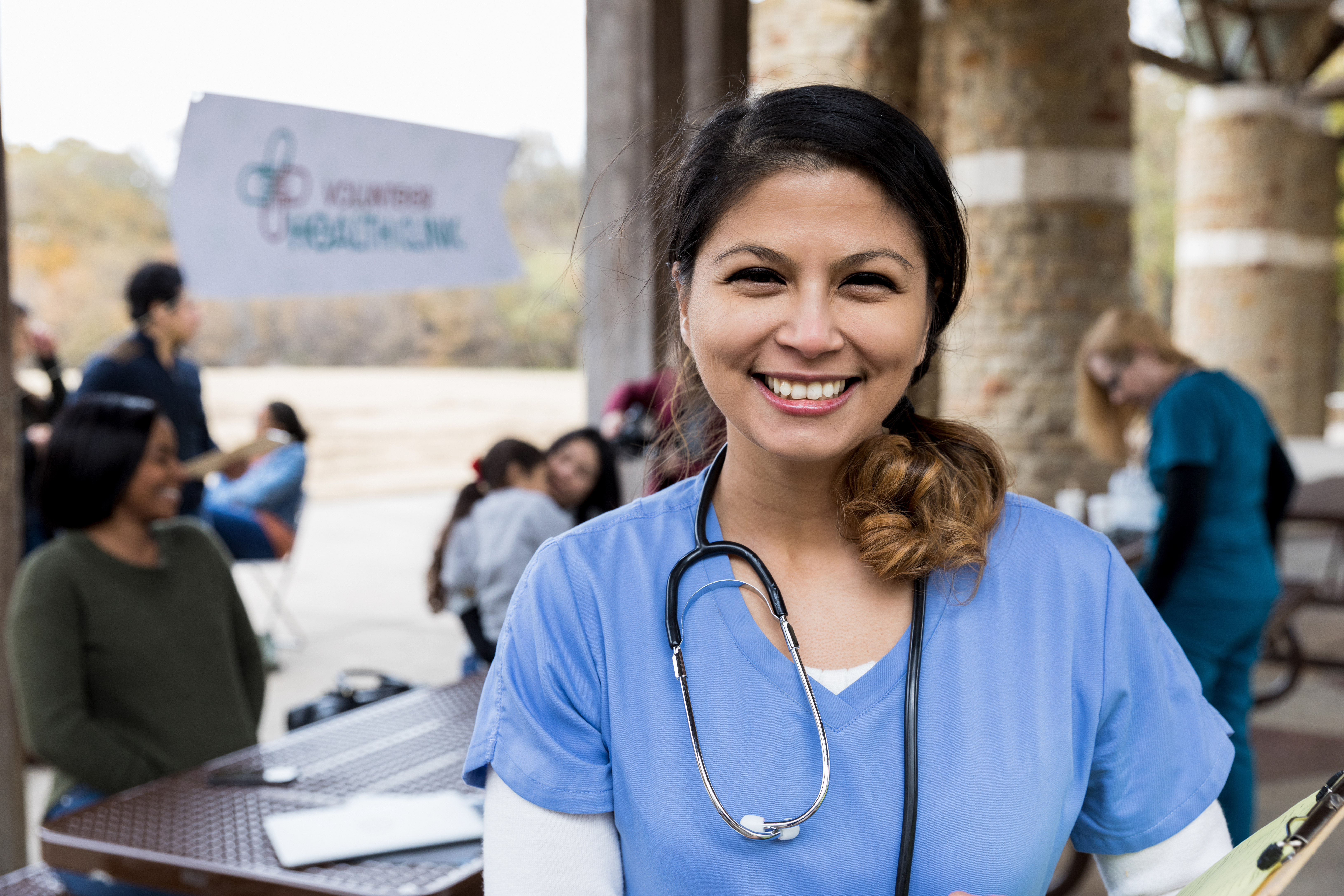 Doctor in front of community gathering