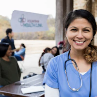 Doctor in front of community gathering