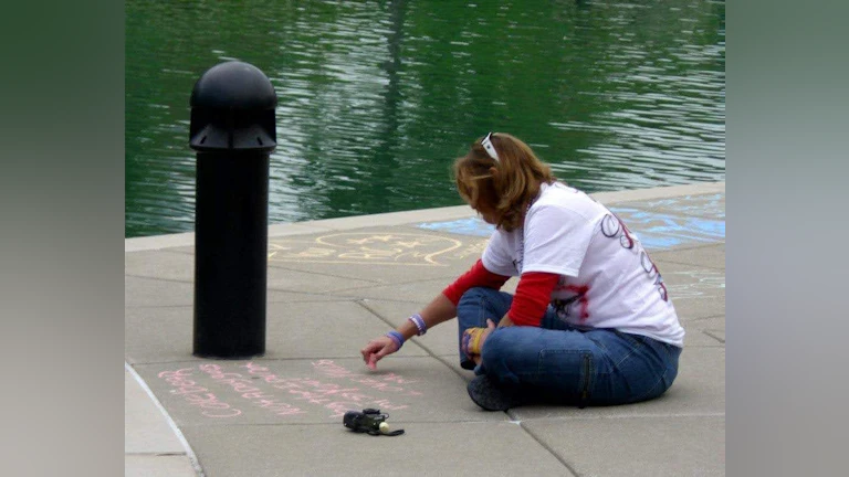 Drawing with chalk on sidewalk