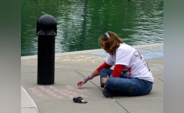 Drawing with chalk on sidewalk