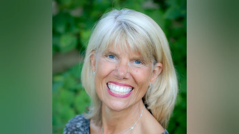 Headshot of Beverly smiling at the camera