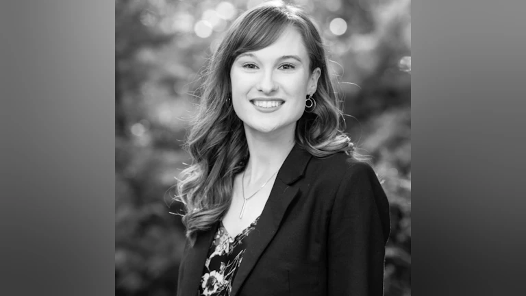 Headshot of Katie smiling and looking at the camera