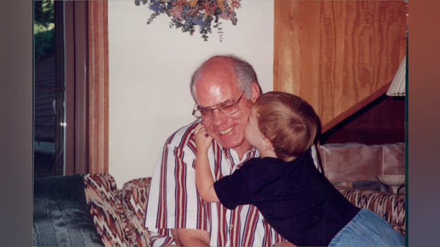Son kissing father on cheek