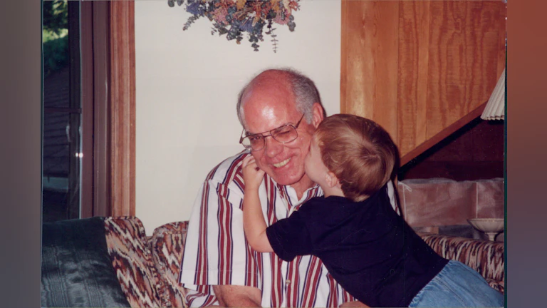 Son kissing father on cheek