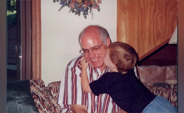 Son kissing father on cheek