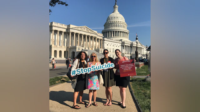 Wendy Sefcik and advocate friends holding a #StopSuicide sign in front of the State Capitol