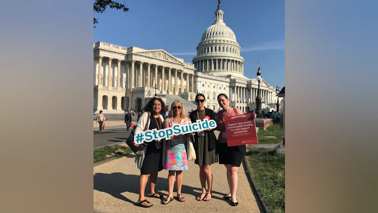 Wendy Sefcik and advocate friends holding a #StopSuicide sign in front of the State Capitol