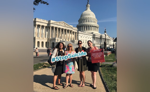 Wendy Sefcik and advocate friends holding a #StopSuicide sign in front of the State Capitol