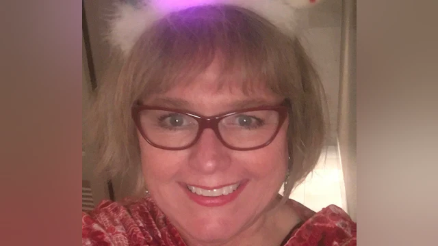 Headshot of Sarah Miller wearing glasses and smiling at the camera