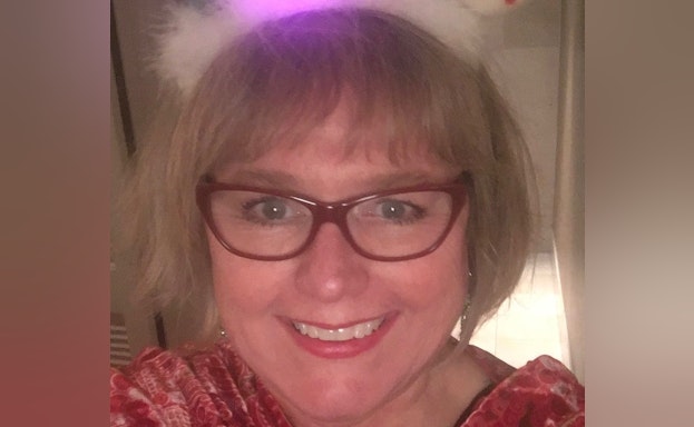 Headshot of Sarah Miller wearing glasses and smiling at the camera