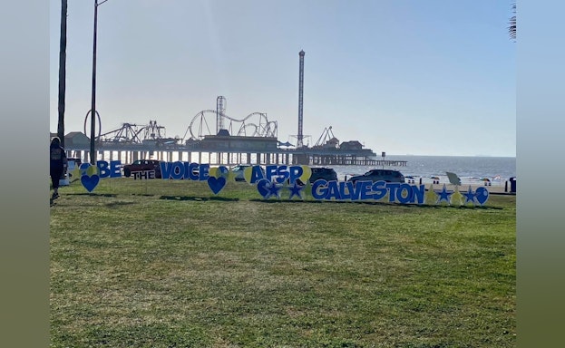 A standing sign that reads, "Be the voice for Galveston"