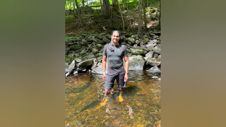 Kenny Cruz standing in shallow water.