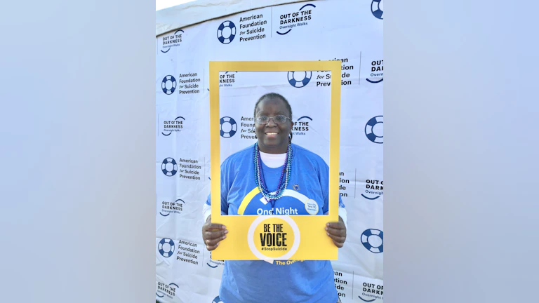 Catharyn Turner posing with a "Be The Voice" photo frame at an Out of The Darkness walk